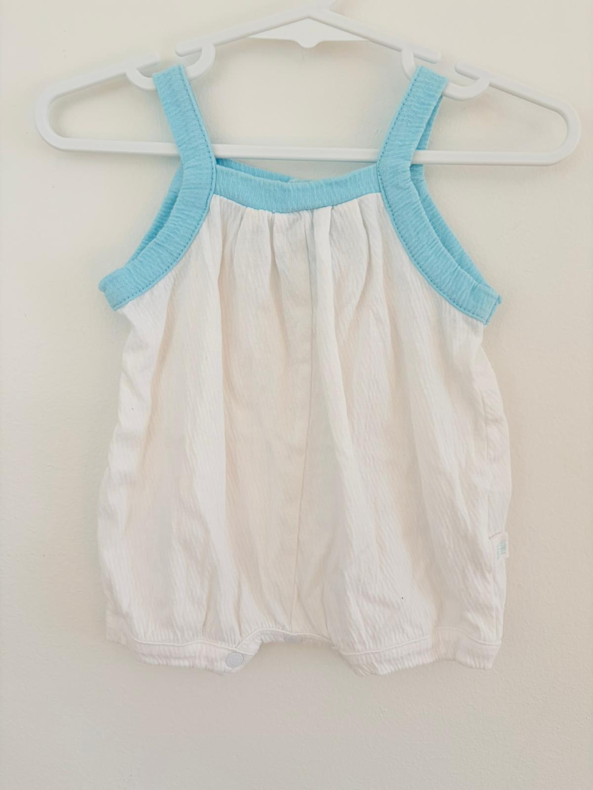 Newborn pumpkin patch white baggy romper with blue trim.