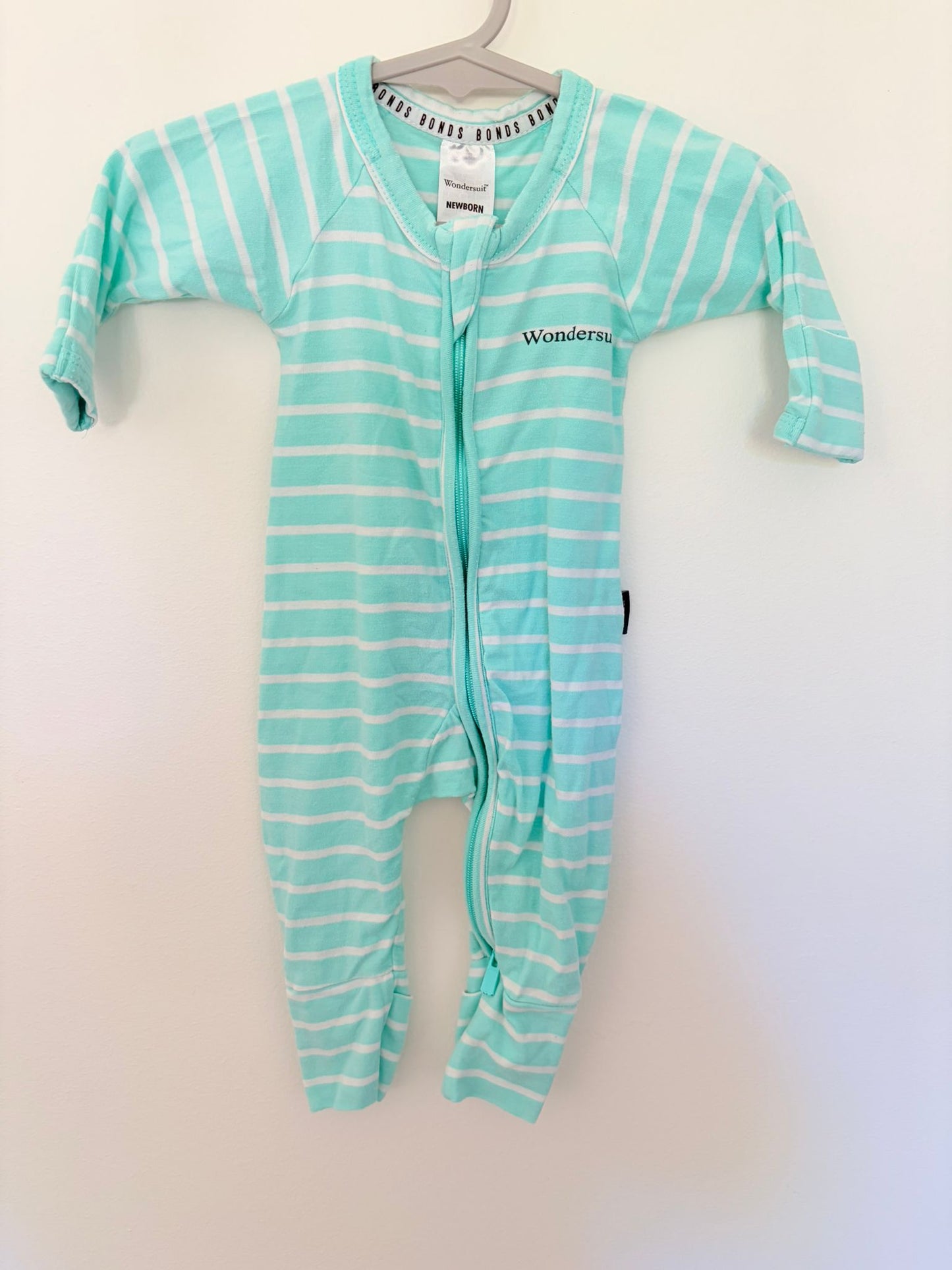 Newborn Bonds wondersuit teal/white stripes.