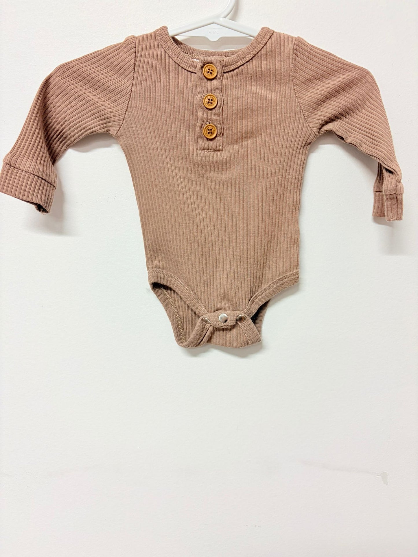 Newborn La Sienna couture long sleeve ribbed brown bodysuit.