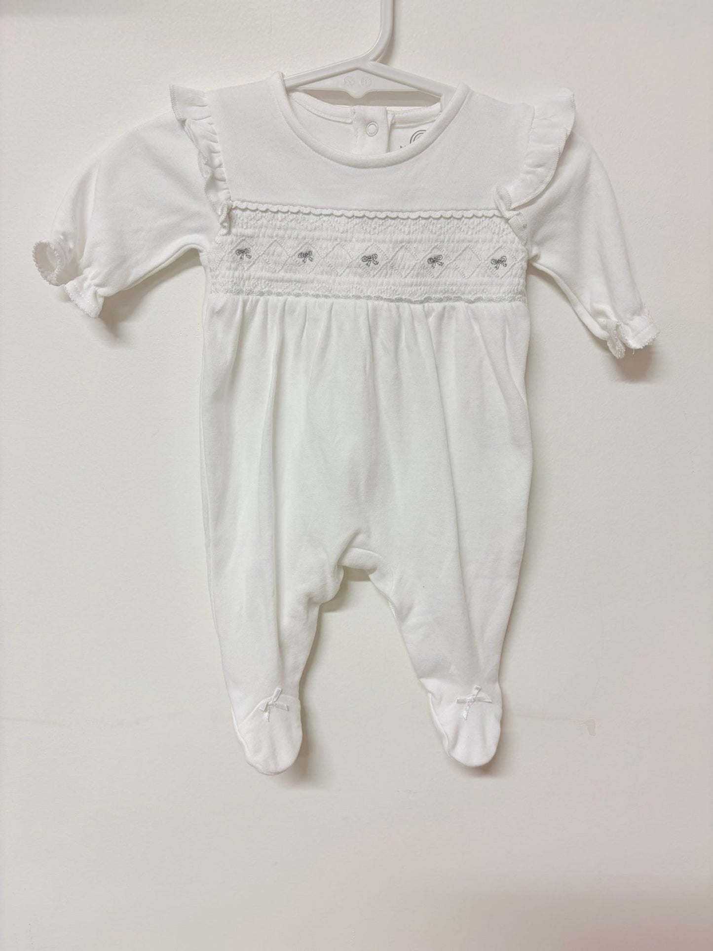 Newborn Next white onesie.