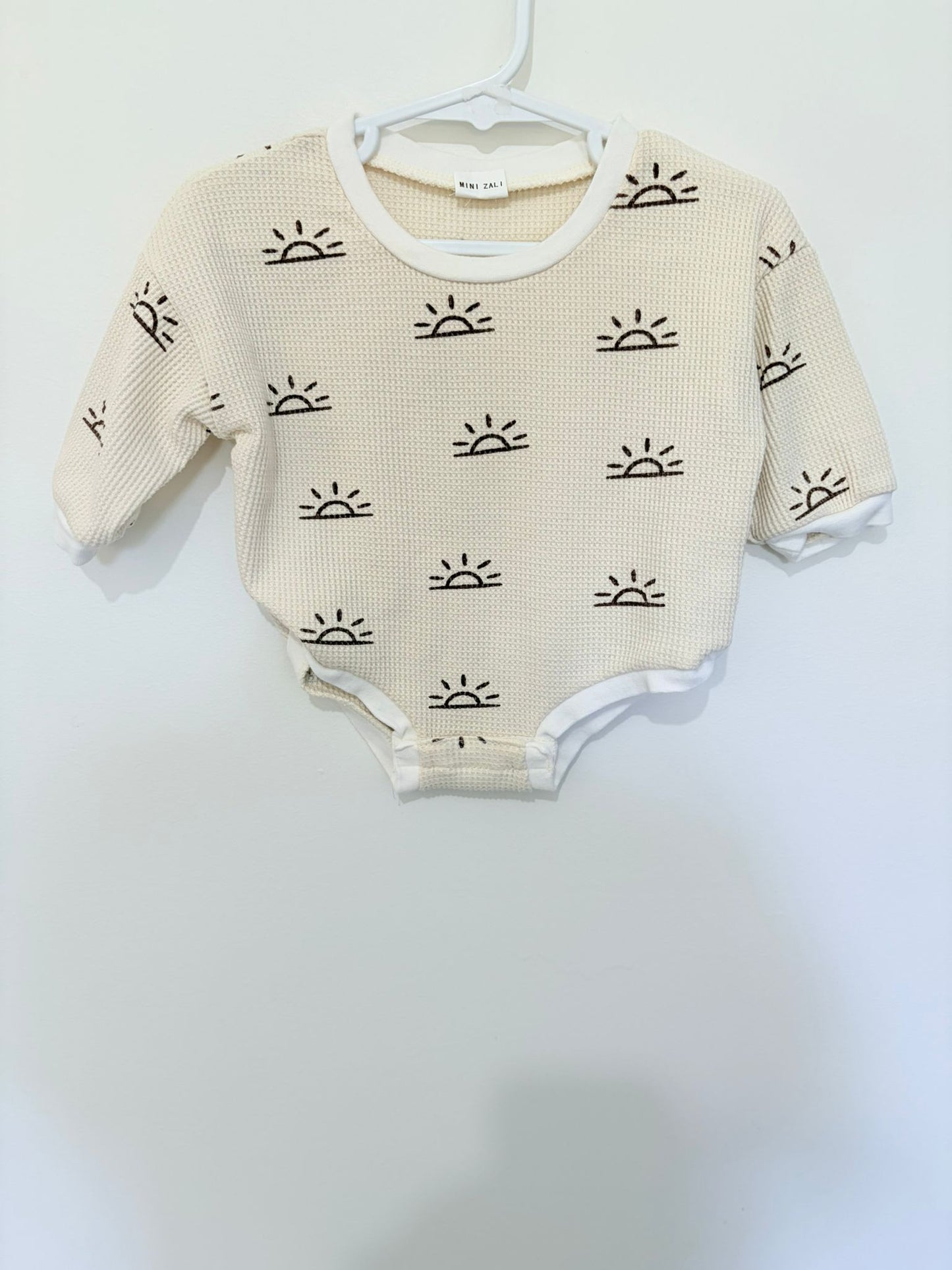 Size 000 Mini Zali long sleeve bodysuit beige sun print.