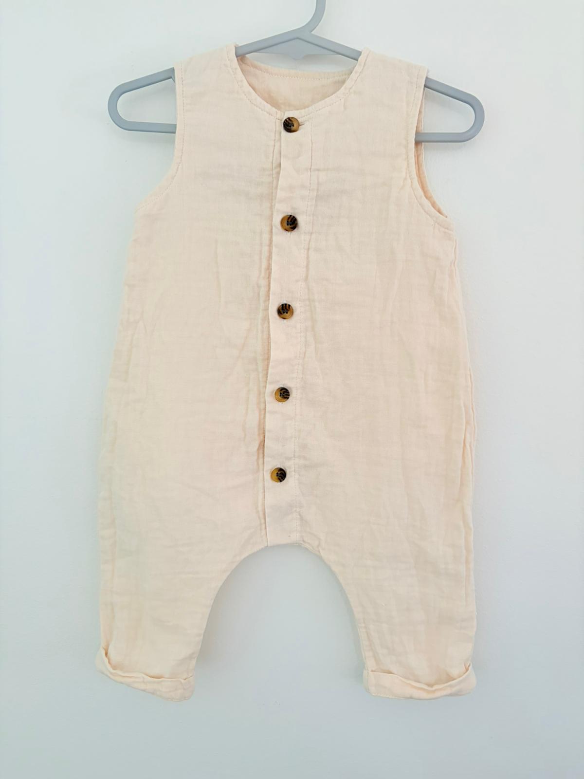 Size 00 Baby baby beige cotton sleeveless onesie.