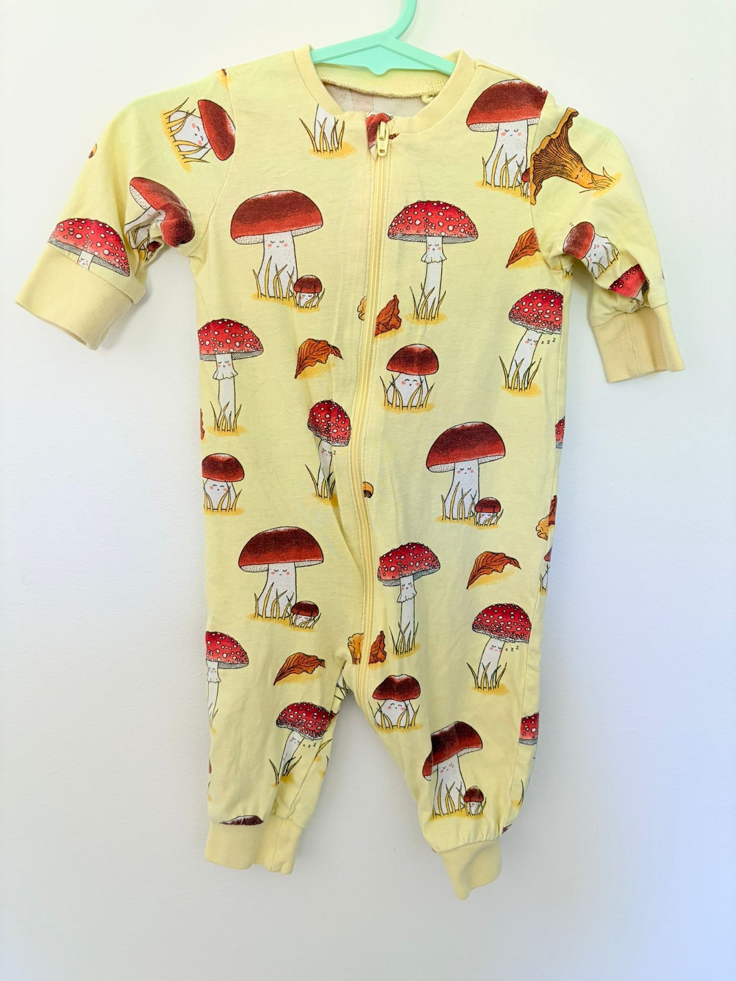 Size 000 Lin X yellow mushroom print zip up bodysuit.