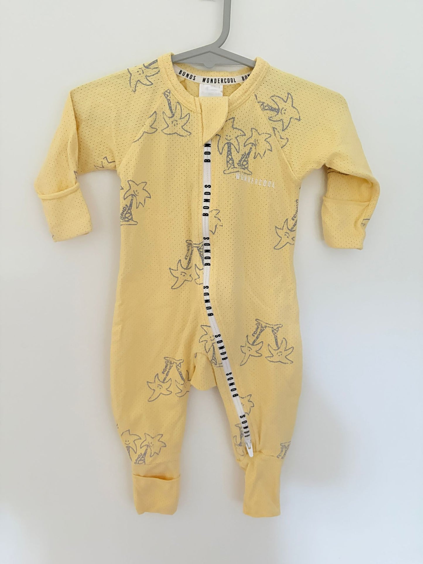 Size 000 Bonds wondercool yellow palm tree print onesie.