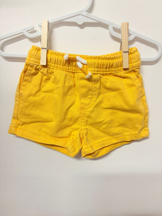 Size 000 Seed yellow shorts embroidered logo.