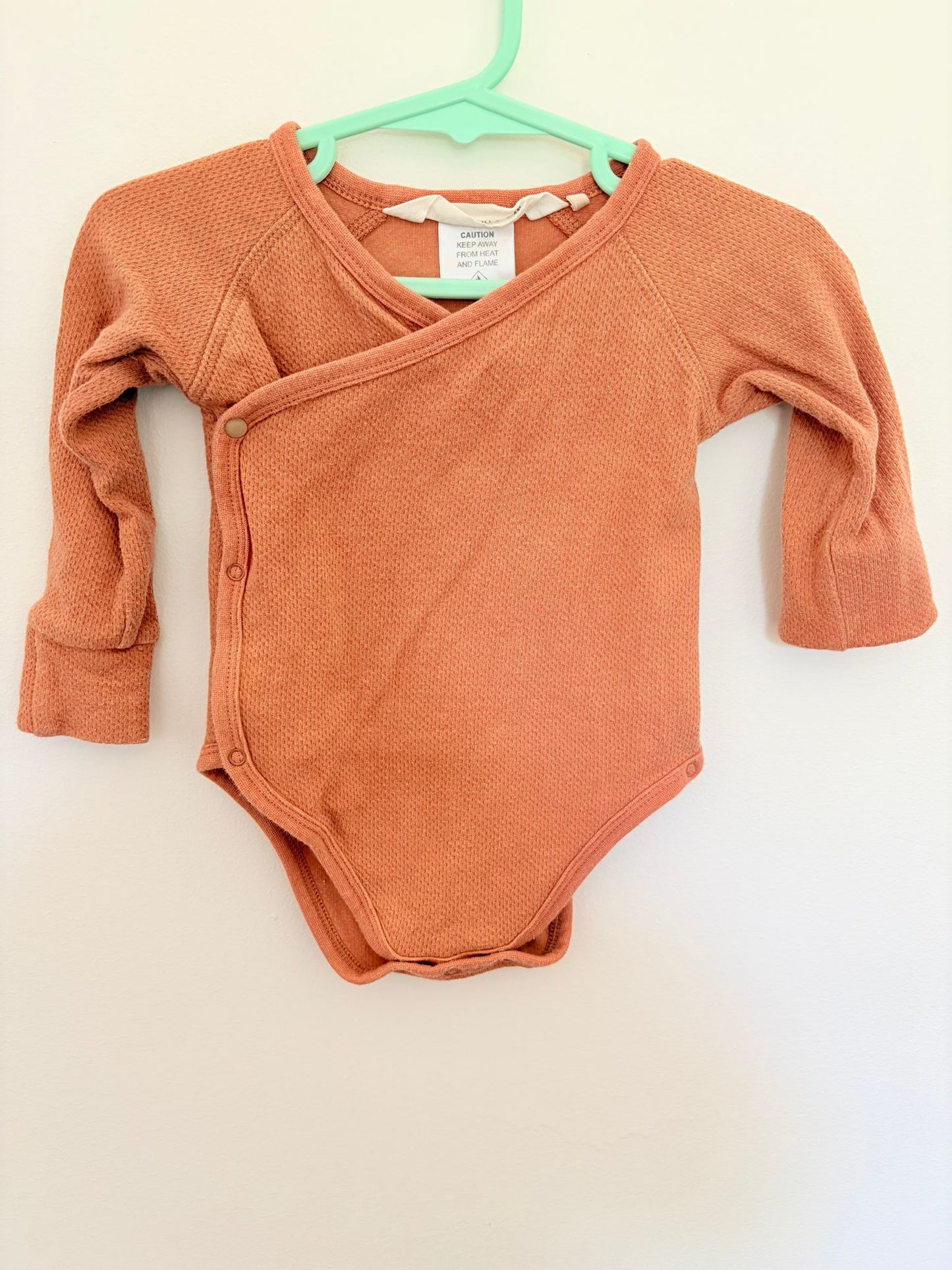 00 Susukoshi burnt orange bodysuit.