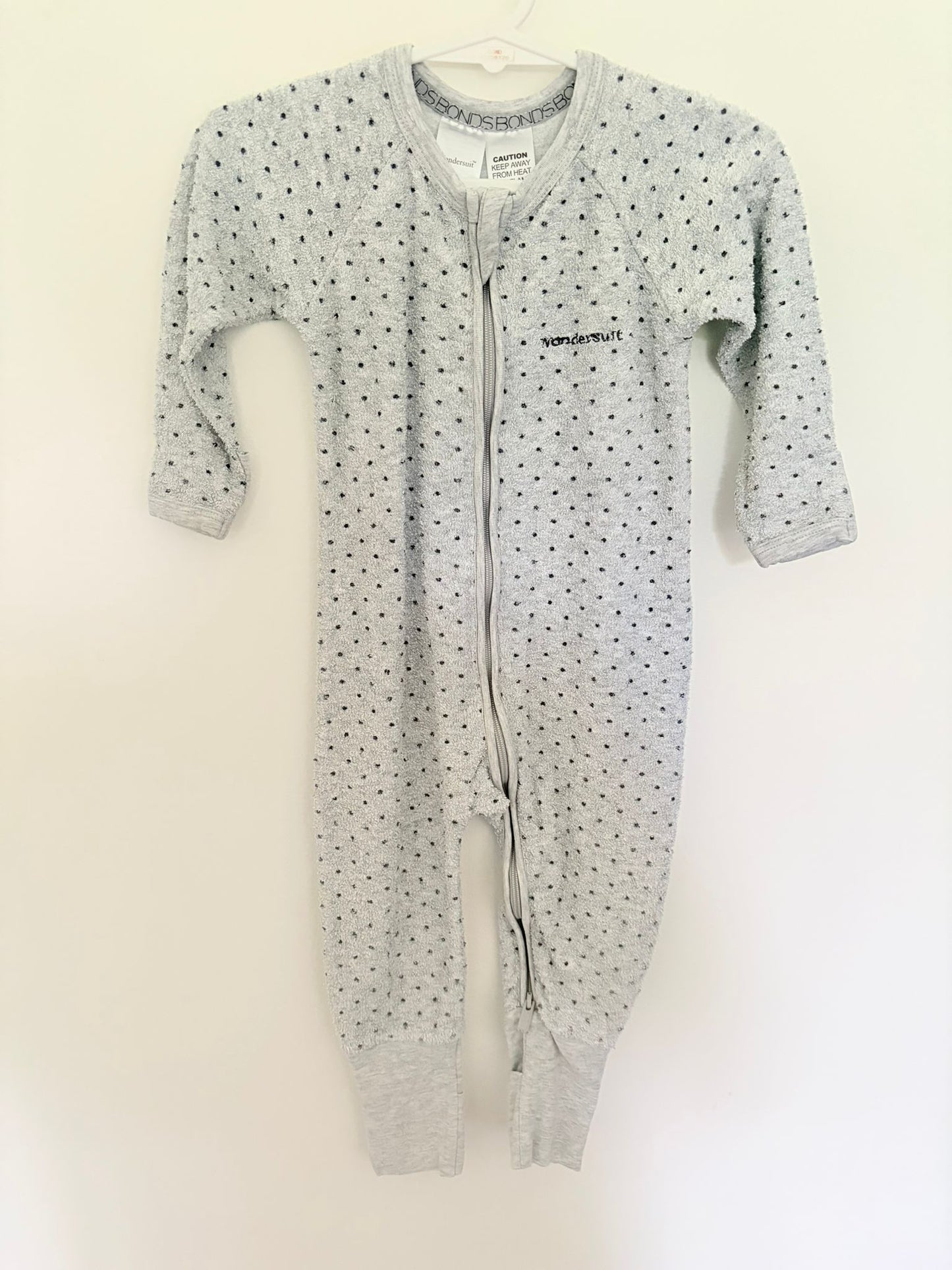 Size 0 Bonds wondersuit flannelette grey/black polka dots.