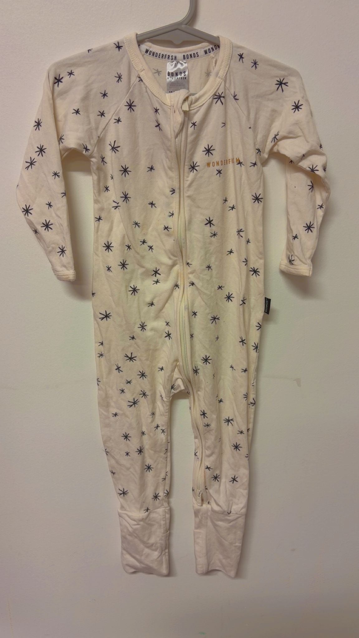 Size 1 Bonds wonderfrsh suit beige with black stars.